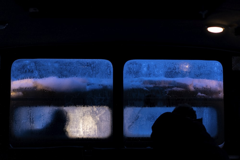 person sitting on chair looking at the window