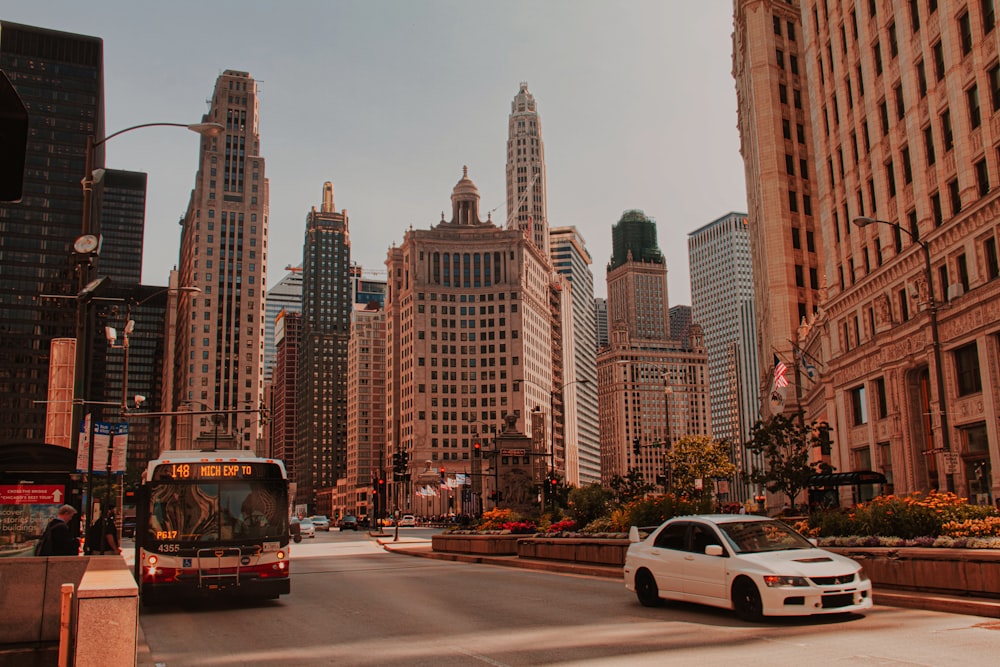 red and black bus on road near high rise buildings during daytime