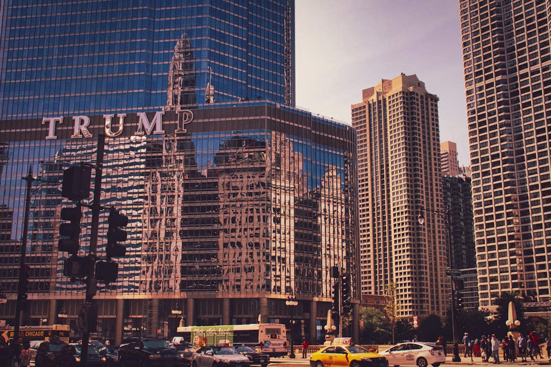 cars parked near high rise buildings during daytime