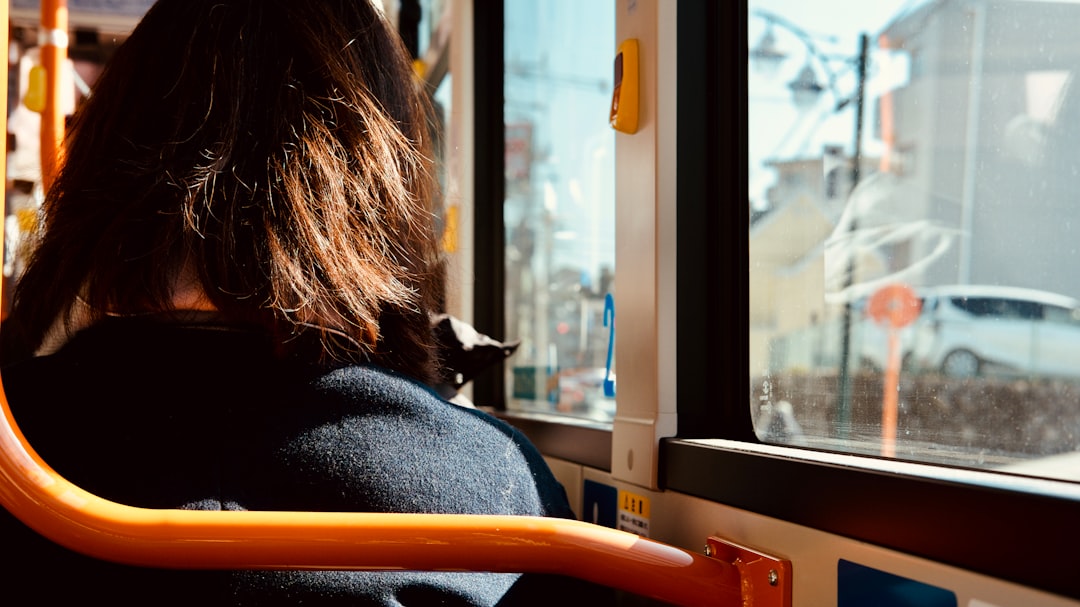 woman in black coat sitting on yellow chair