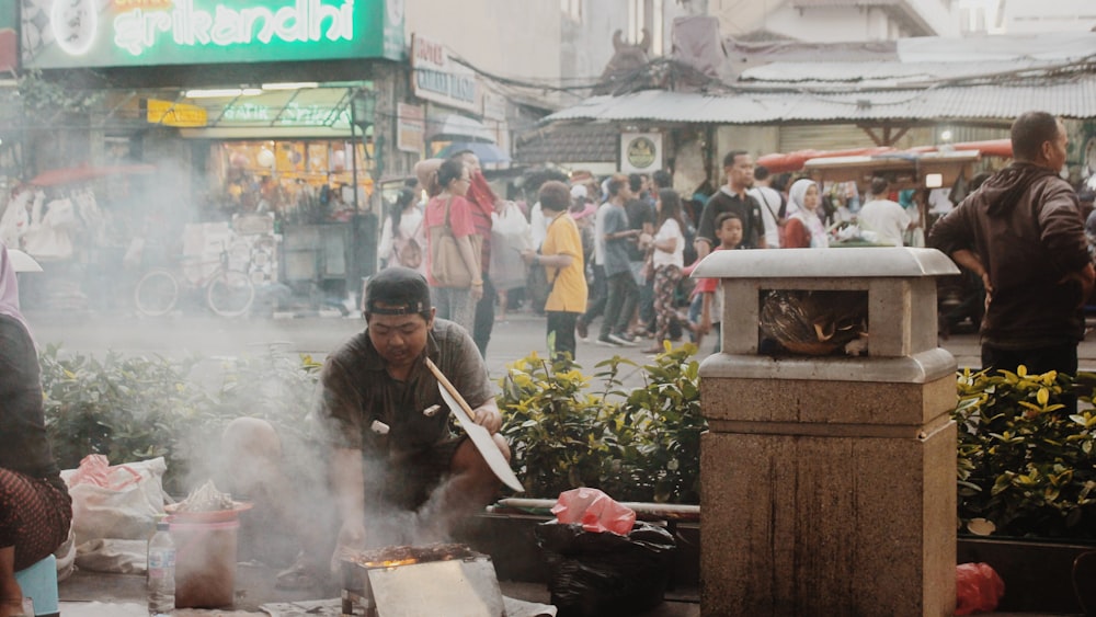 man in black jacket holding chopsticks