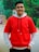 A happy customer wearing a luxurious Clozen hoodie outdoors.