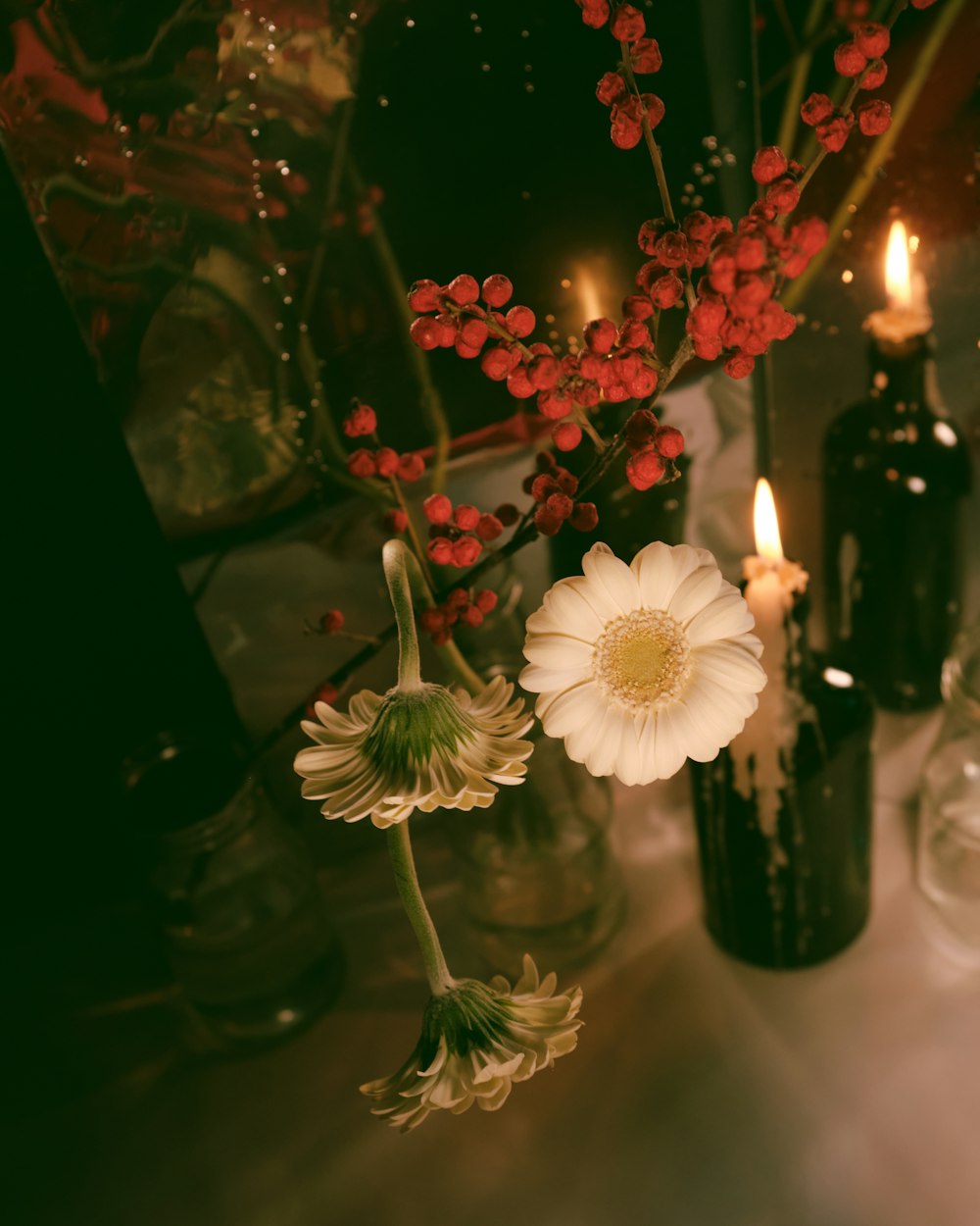 white and red flowers in glass vase