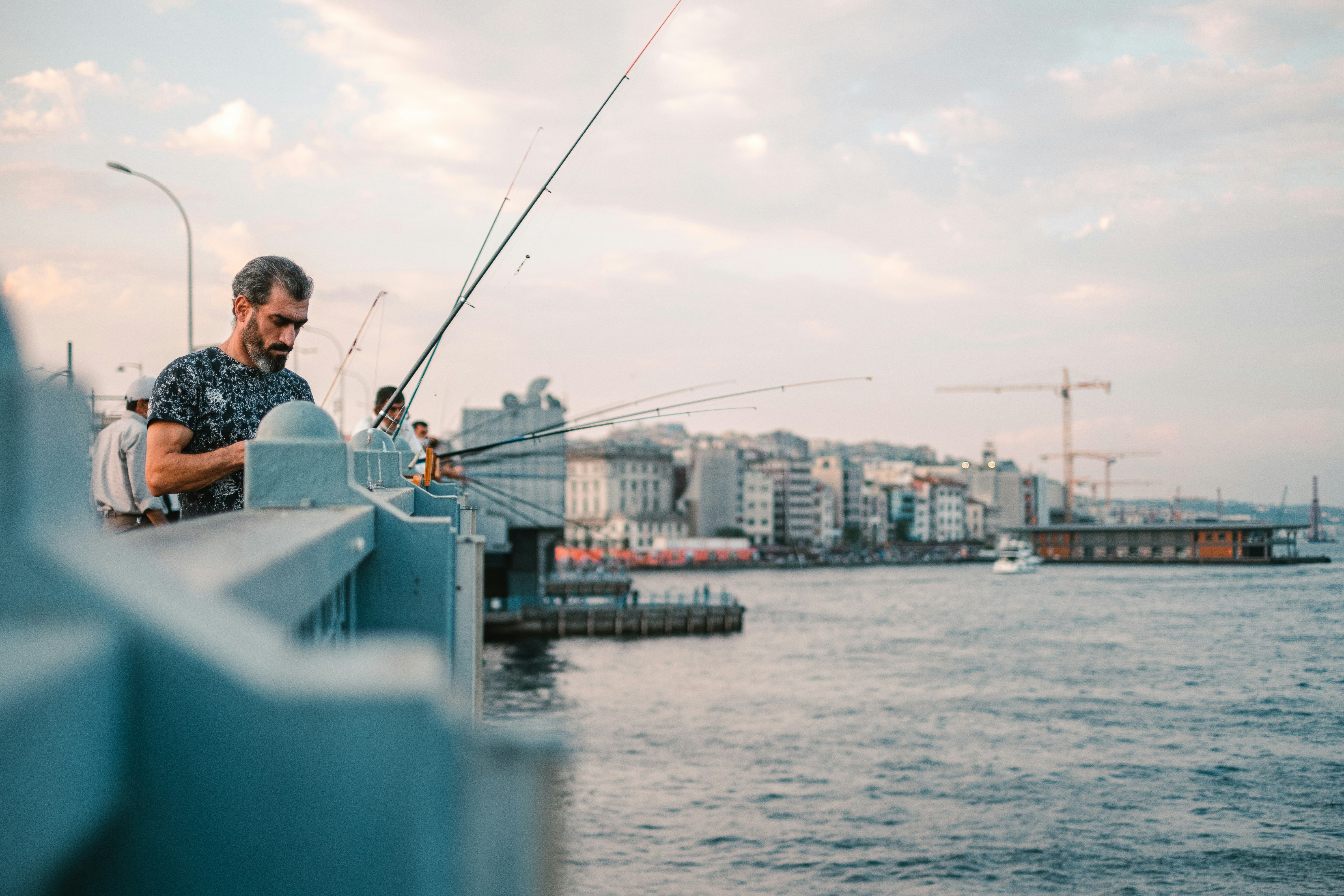 man in white shirt sitting on white boat during daytime