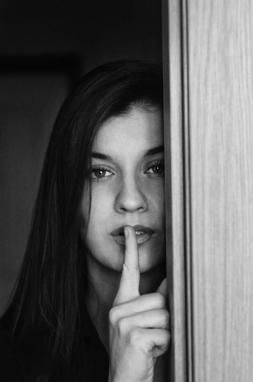 grayscale photo of woman holding her chin