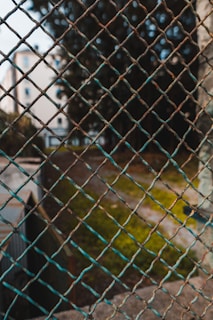 Close-up of galvanized steel agricultural fencing installed around a farm.