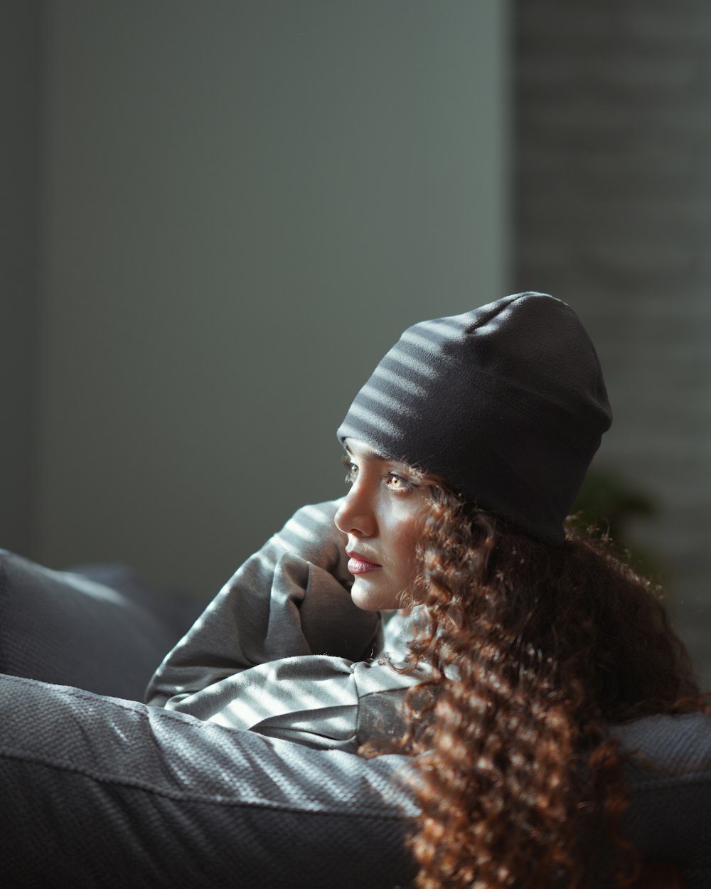 woman in black knit cap and gray jacket