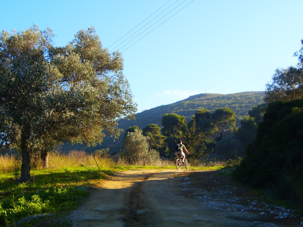 man riding horse on road during daytime