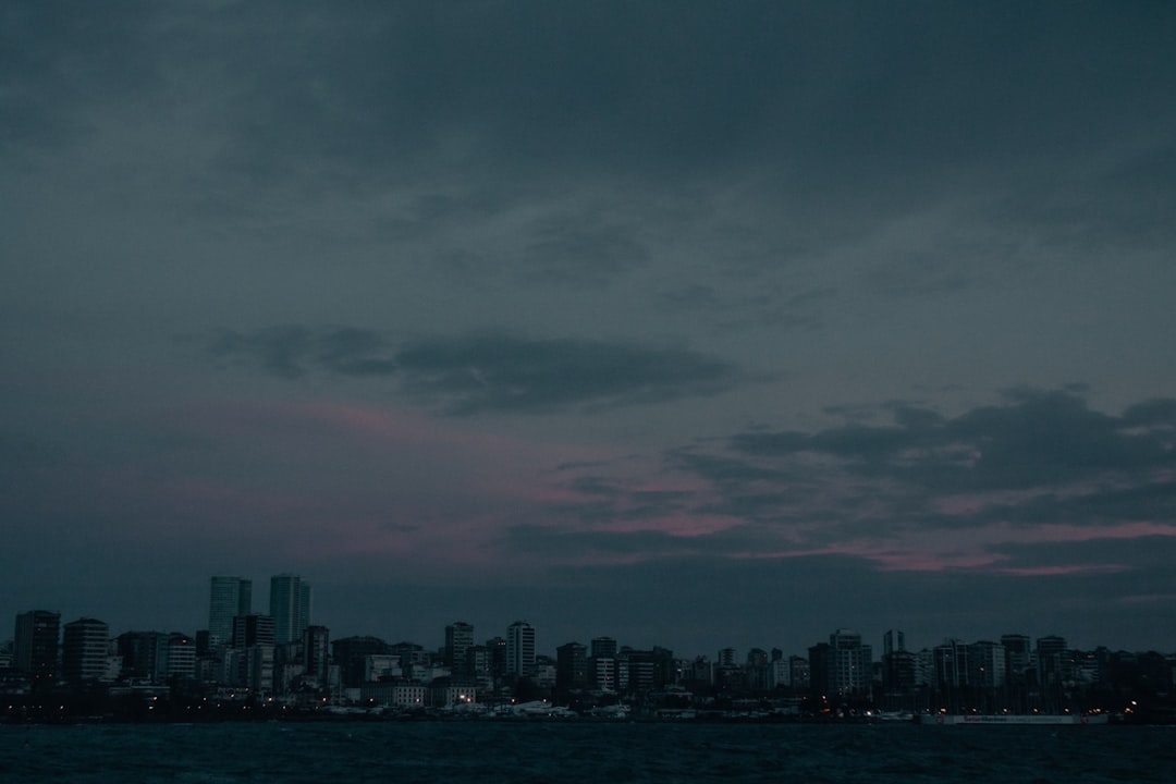 city skyline under gray clouds during daytime