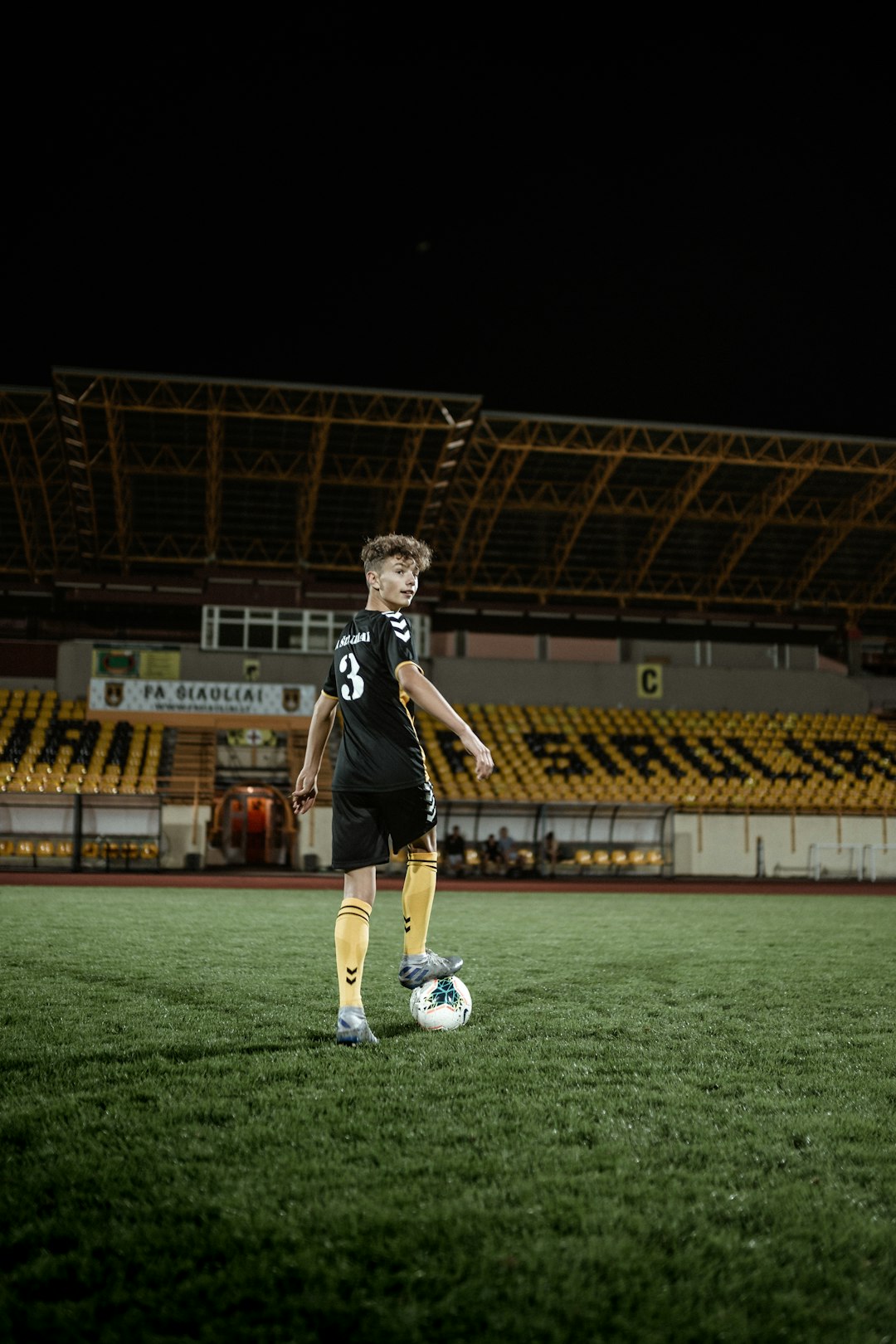 man in black and white jersey shirt playing soccer