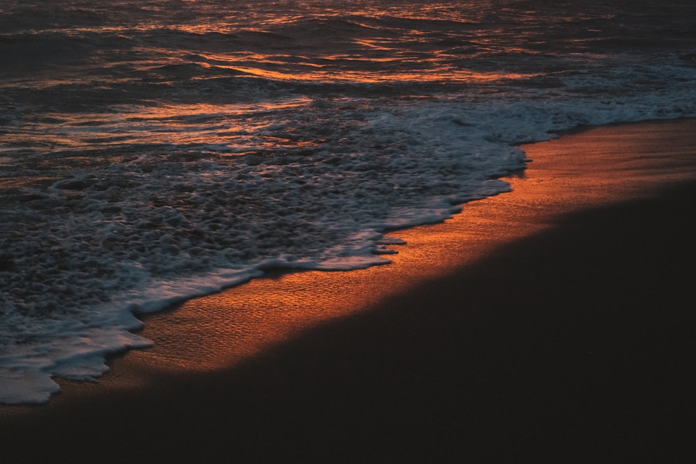 ocean waves crashing on shore during daytime