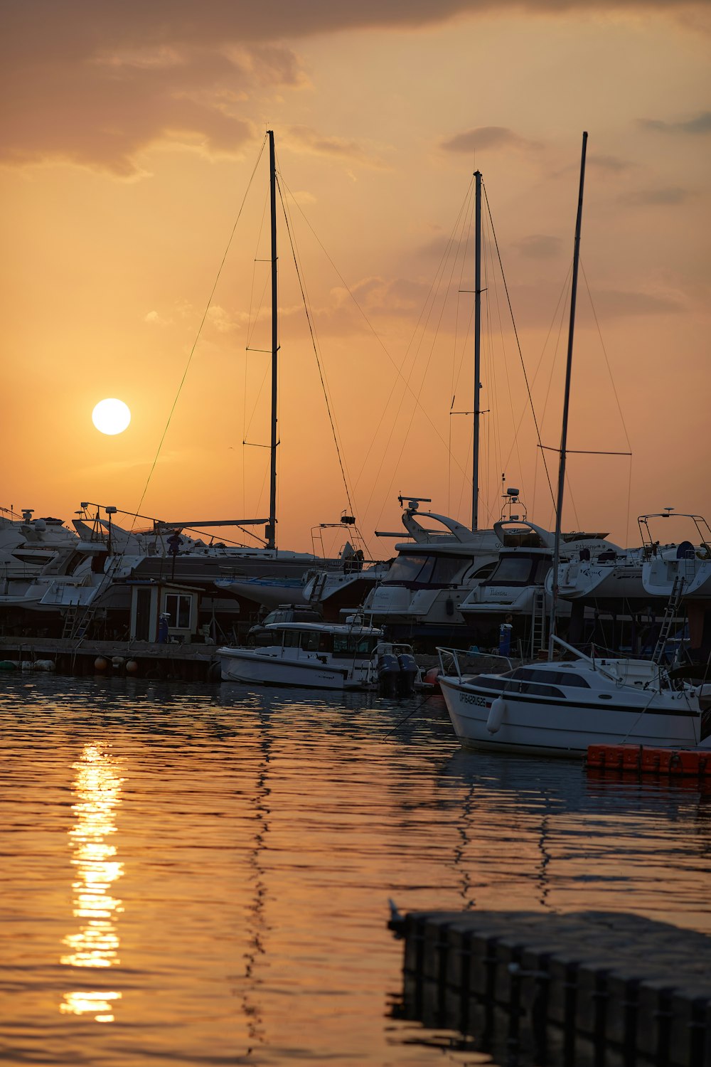 white and black boat on body of water during sunset