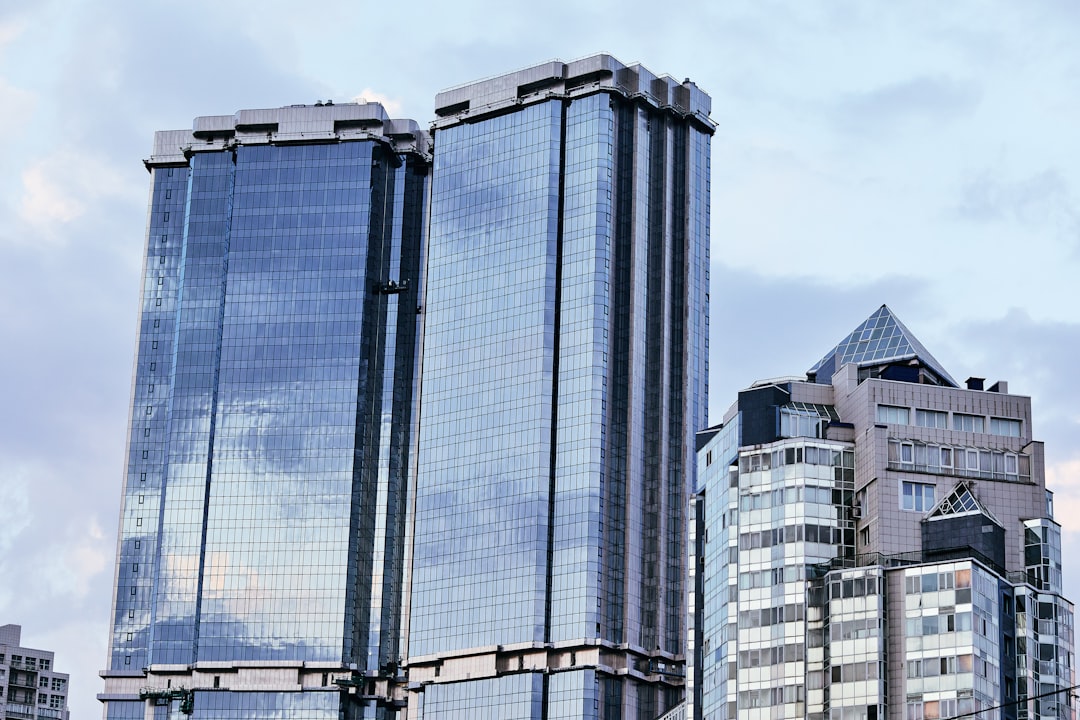 blue and white glass walled high rise building