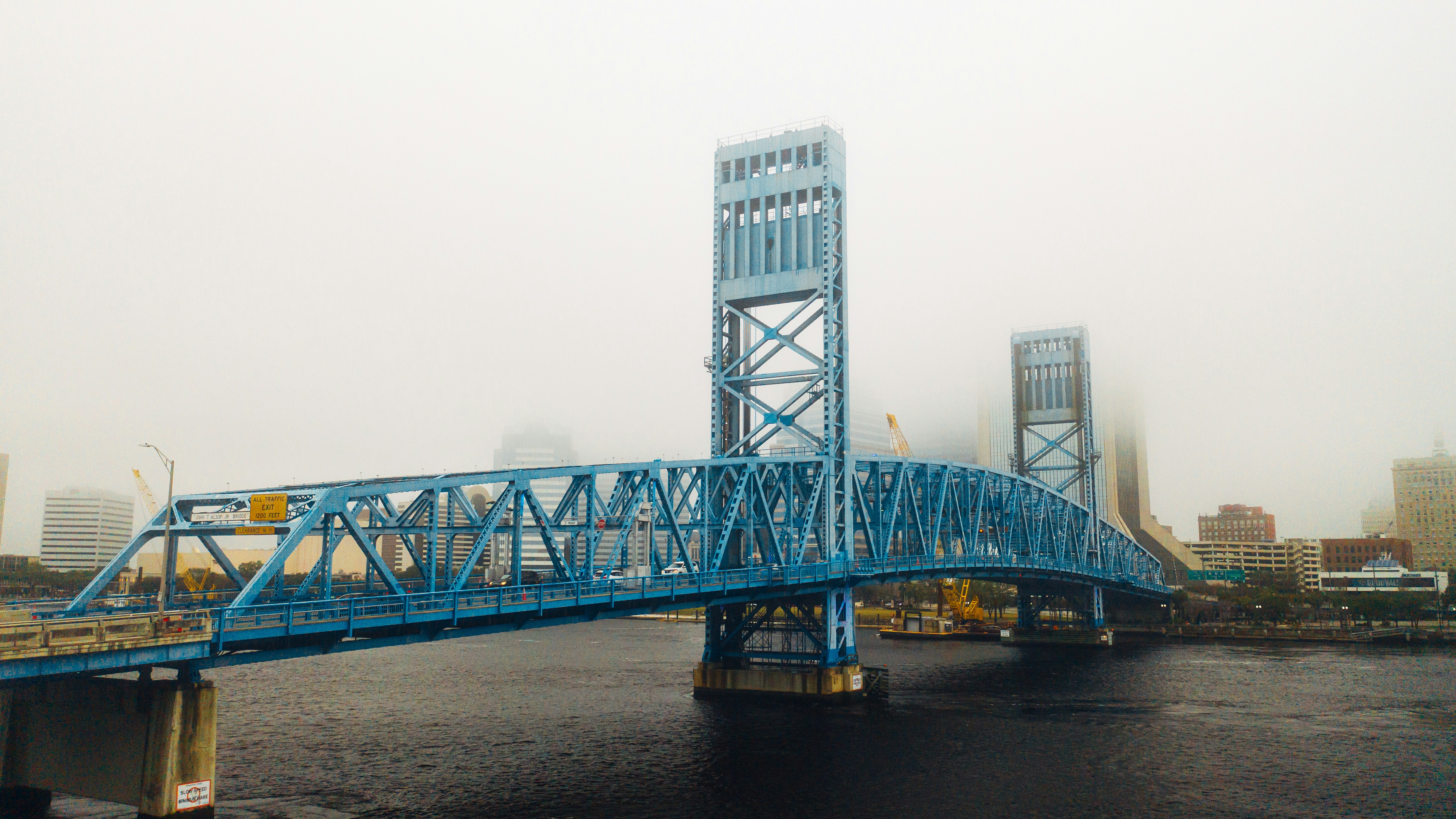 gray steel bridge over body of water during daytime