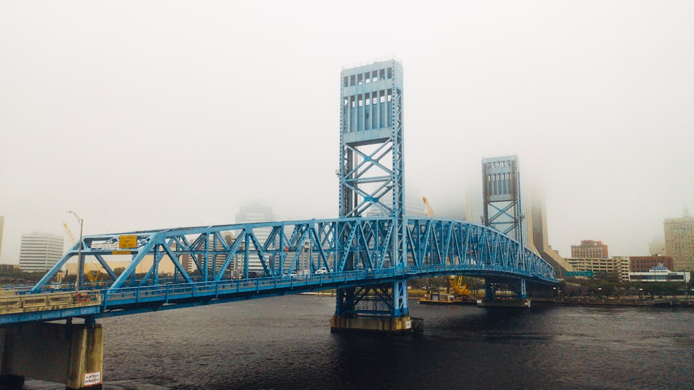 gray steel bridge over body of water during daytime