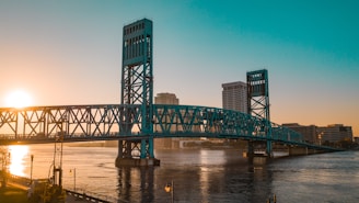 green metal bridge over river during daytime