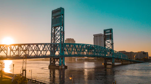 green metal bridge over river during daytime