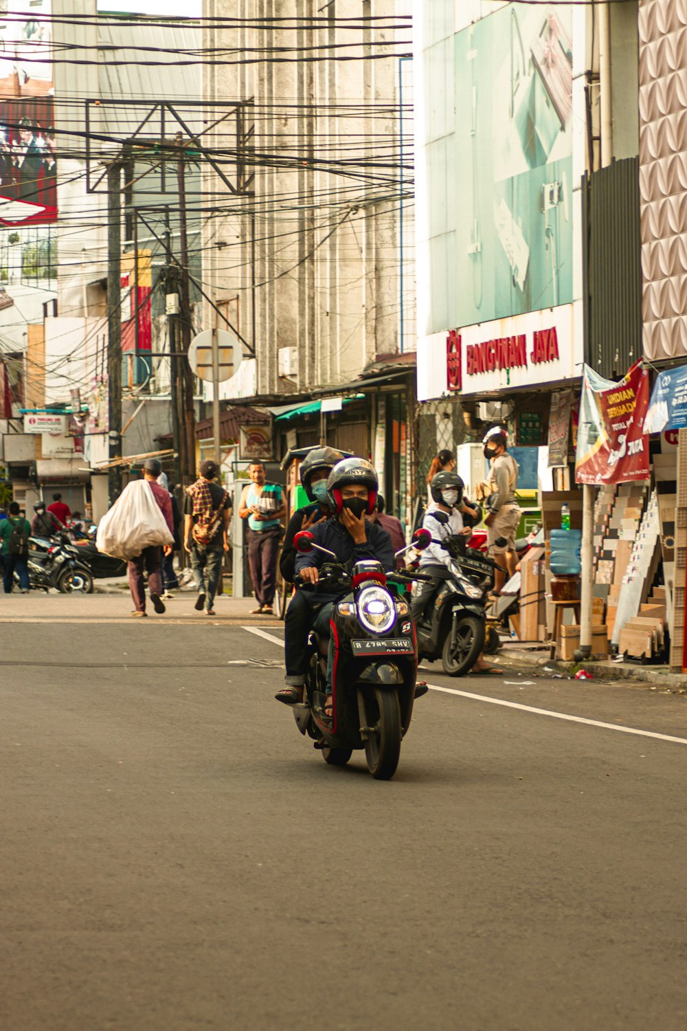 people riding motorcycle on road during daytime