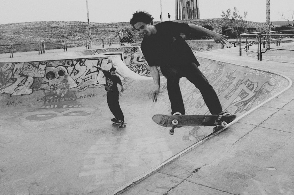 man in black jacket and pants riding skateboard