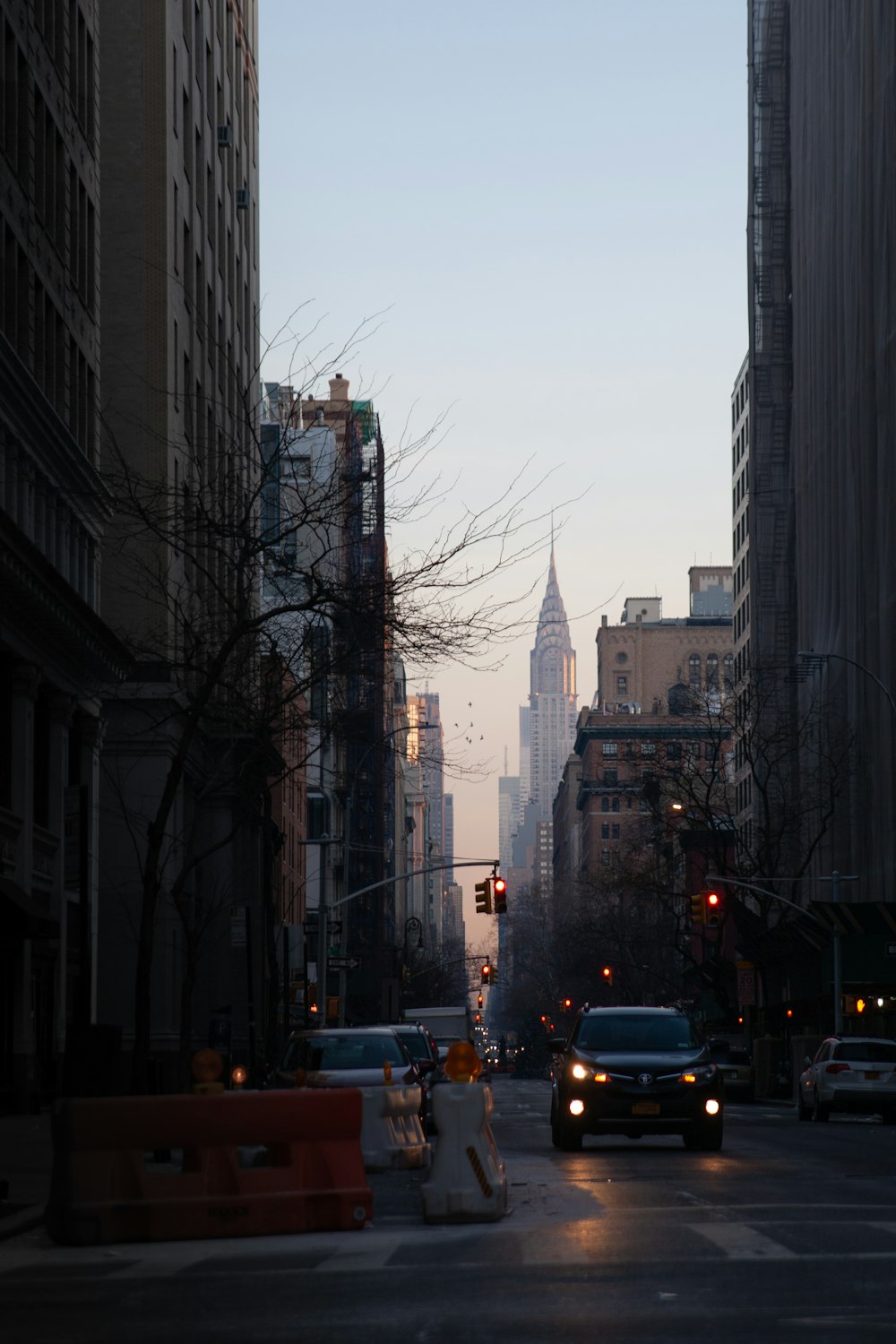 cars on road near high rise buildings during daytime