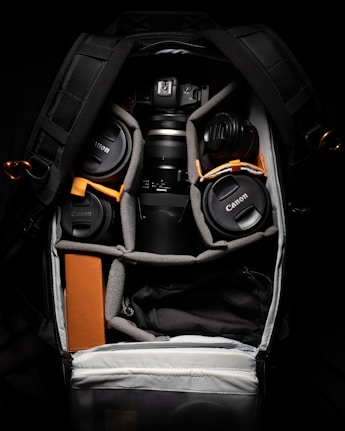 black and orange backpack on white textile