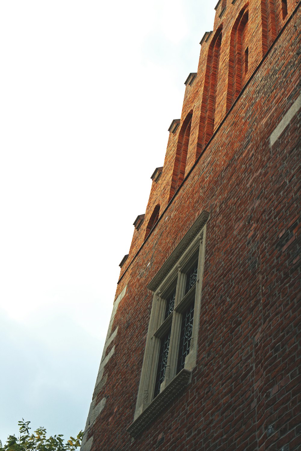 brown brick building under white sky during daytime