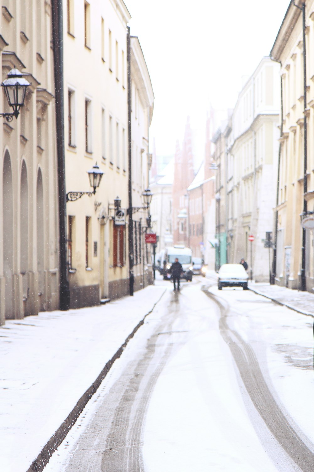 people walking on sidewalk between buildings during daytime