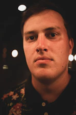 man in black and brown collared shirt