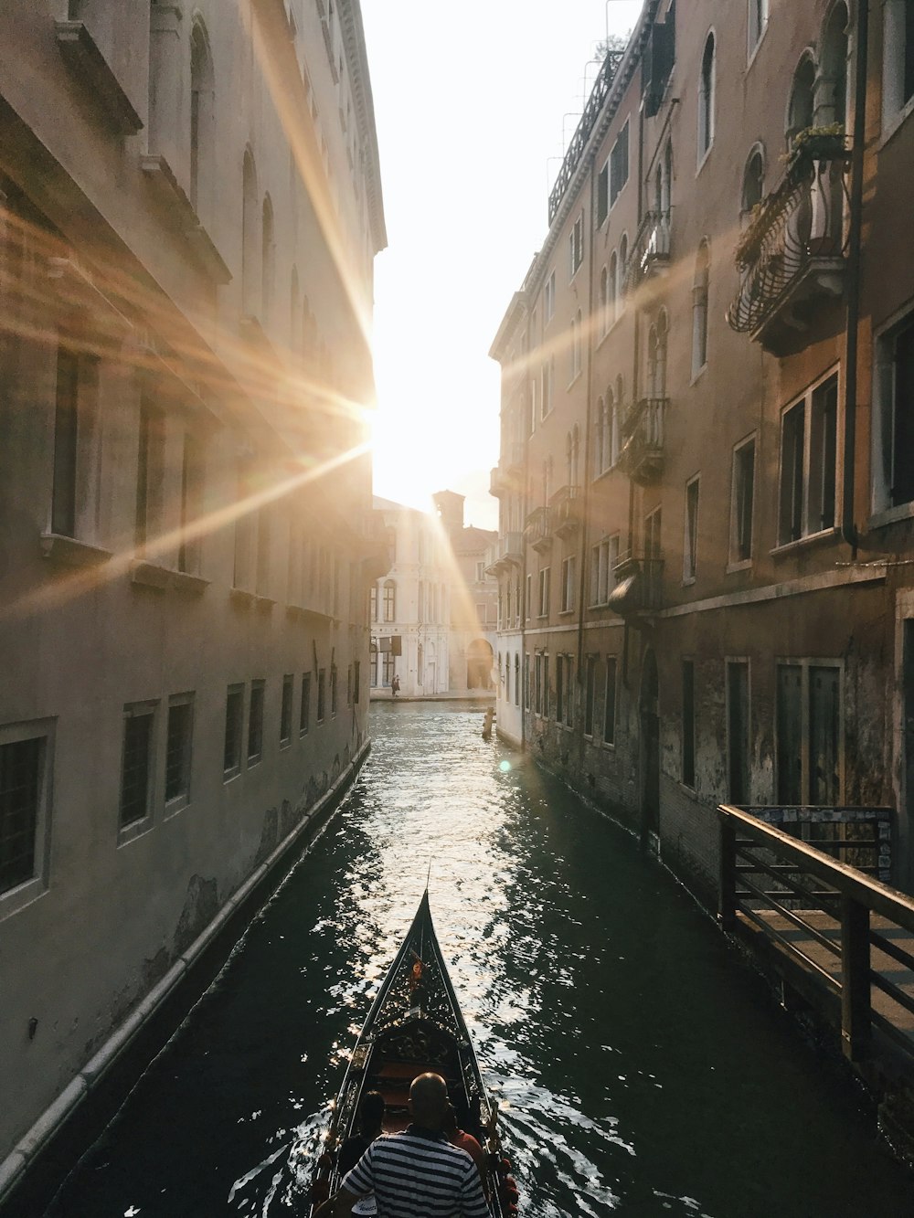 boat on river between buildings during daytime