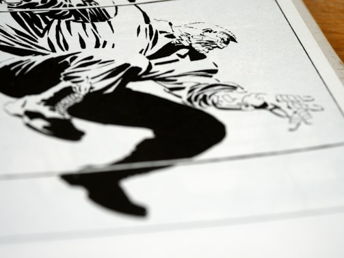 A black and white graphic illustration featuring a dynamic composition of a person in motion. The character is depicted with bold lines and exaggerated features, capturing a sense of movement and tension.