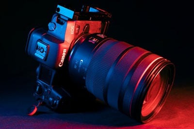 black nikon dslr camera on red textile