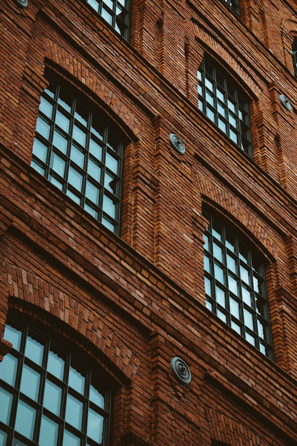 brown brick building with glass windows