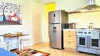 A bright kitchen with stylish appliances and utensils.