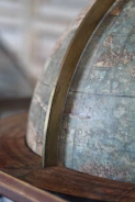 A close-up of a vintage globe with handwritten travel notes pinned around it.