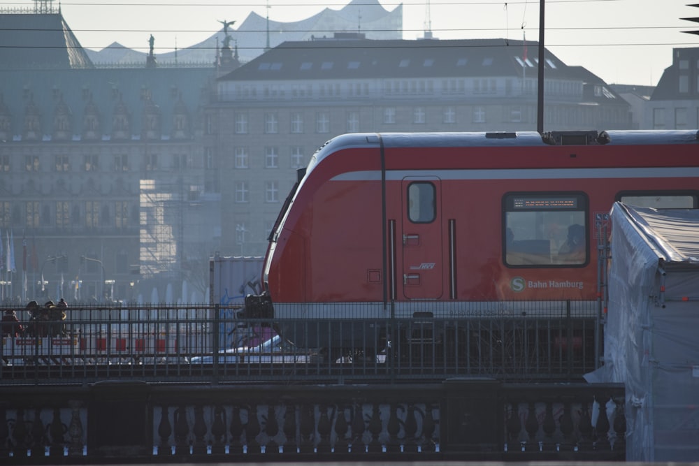 red and white train on rail during daytime