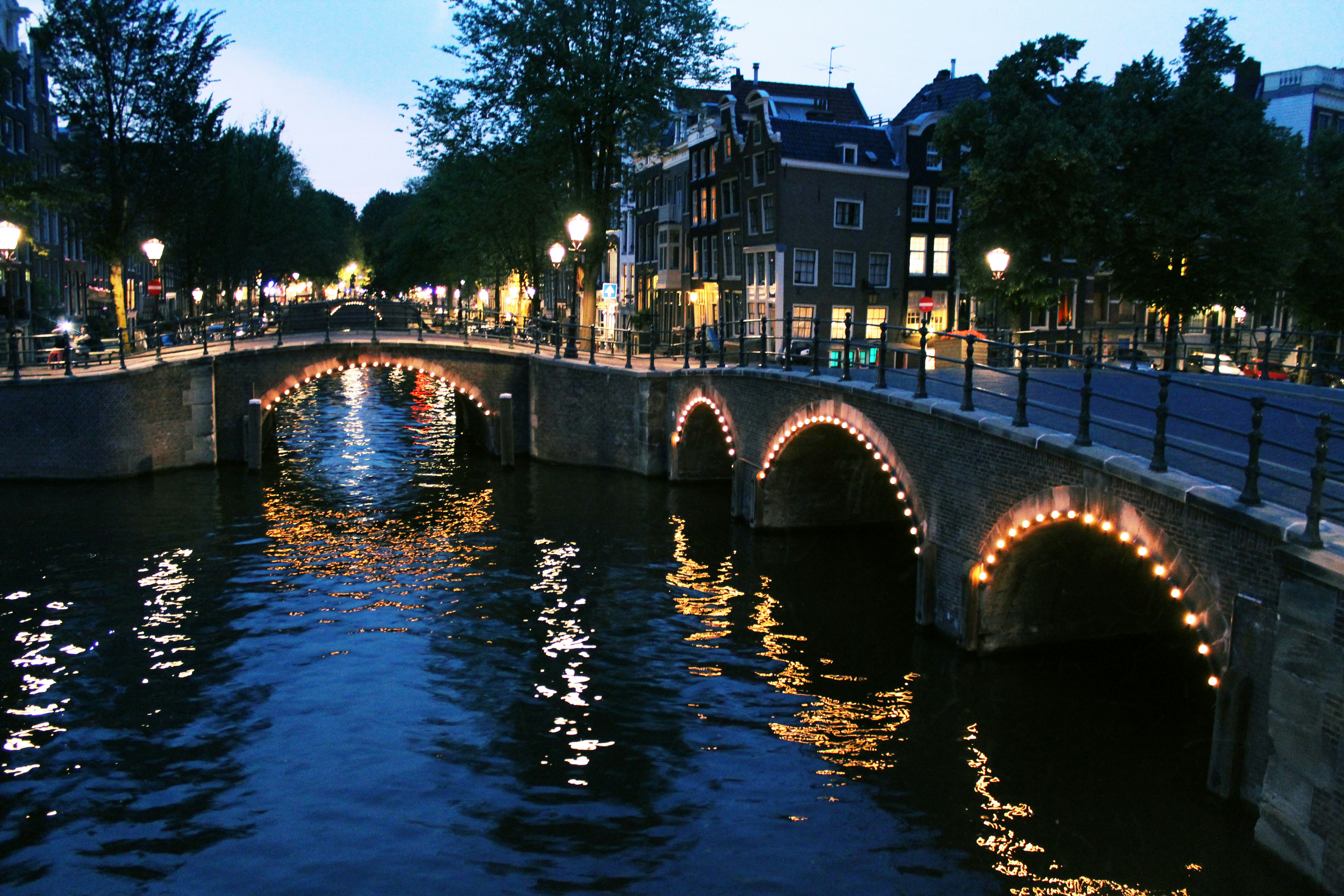 bridge over river near buildings during night time, Amsterdam canal bridge 