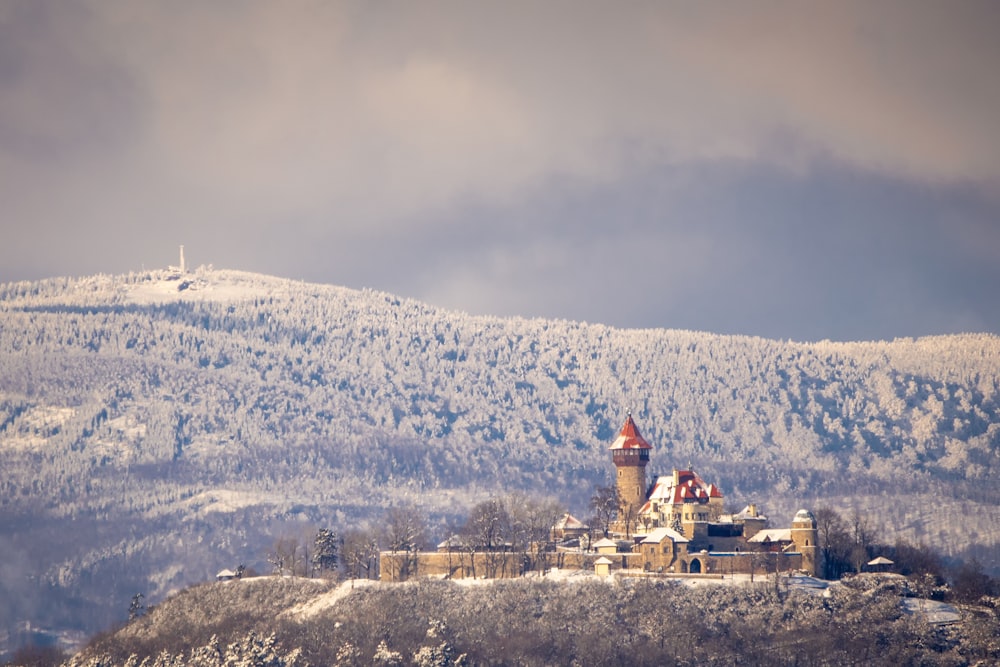 white and red concrete building on top of mountain during daytime