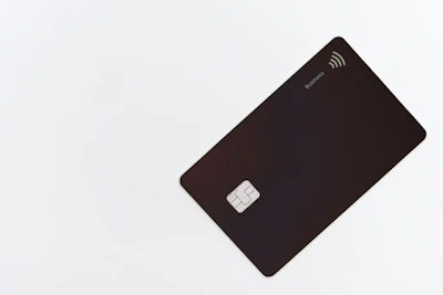 Stylish NFC card with a minimalist geometric design on a wooden surface.