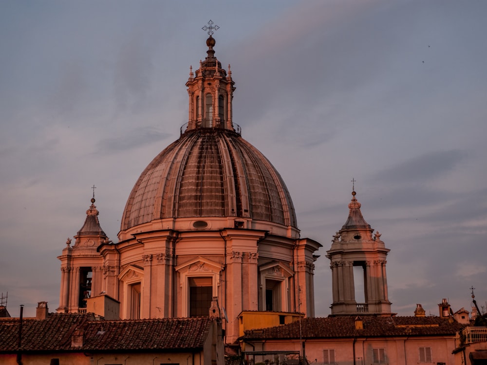 brown and gray dome building under white clouds