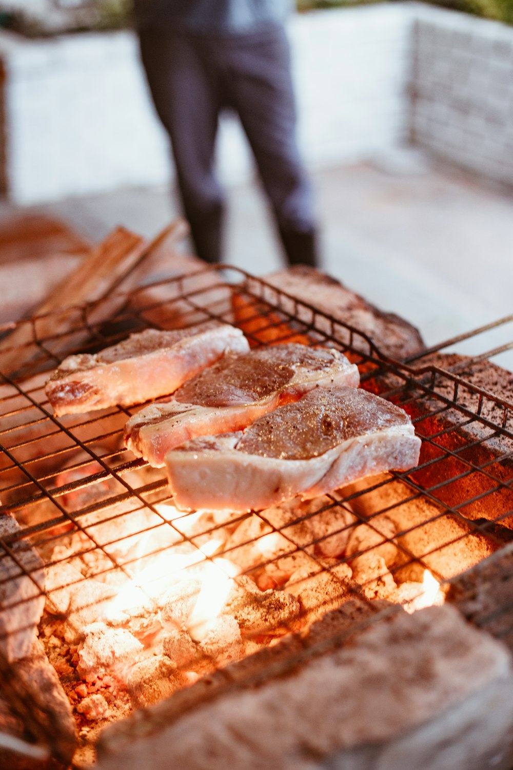 brown and white sliced meat on brown metal grill