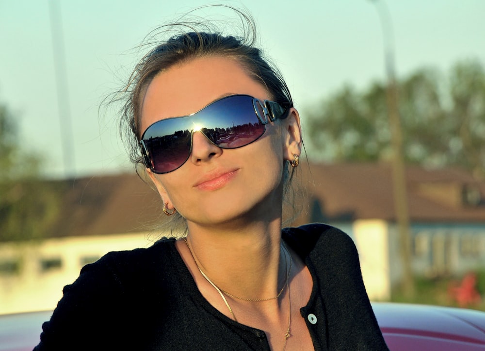 woman in black shirt wearing sunglasses