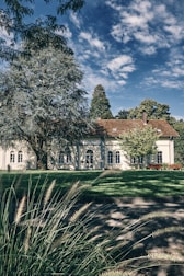 A completed building with a beautiful landscape surrounding it.