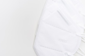 A close-up of soft, breathable daily-use masks neatly arranged on a wooden table.