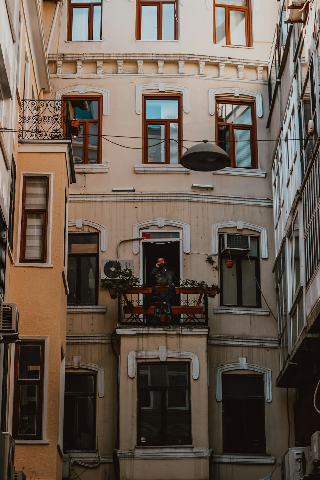 people sitting on chairs in front of building during daytime