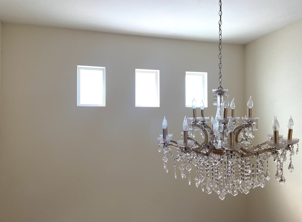 silver and crystal chandelier on white ceiling