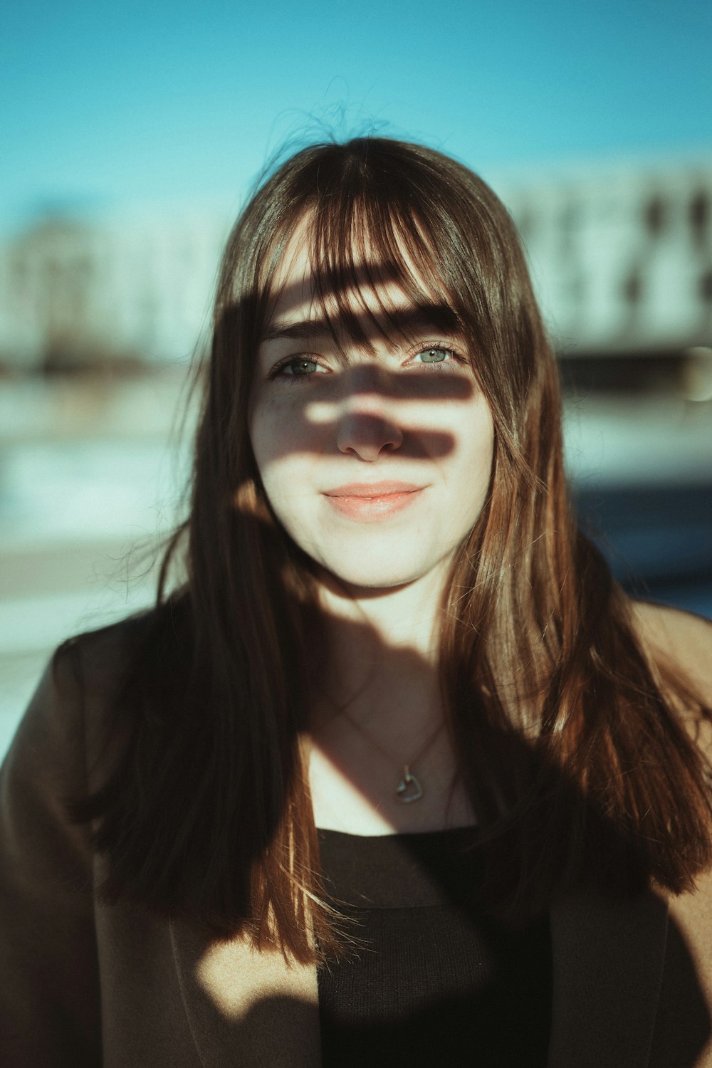 woman in black blazer smiling