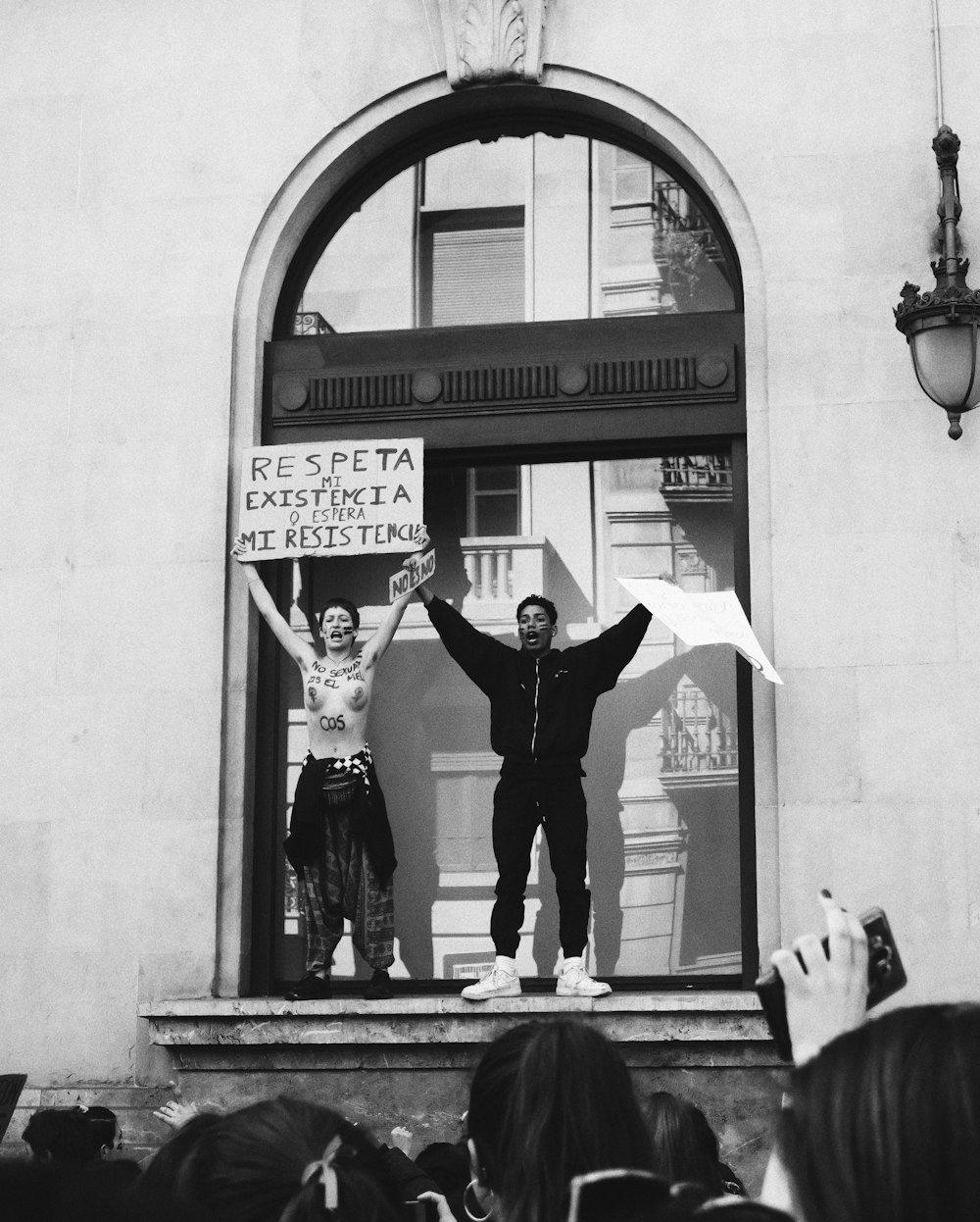 man and woman dancing in front of the building