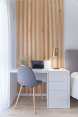 white wooden desk with gray chair