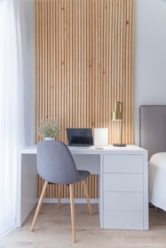 white wooden desk with gray chair