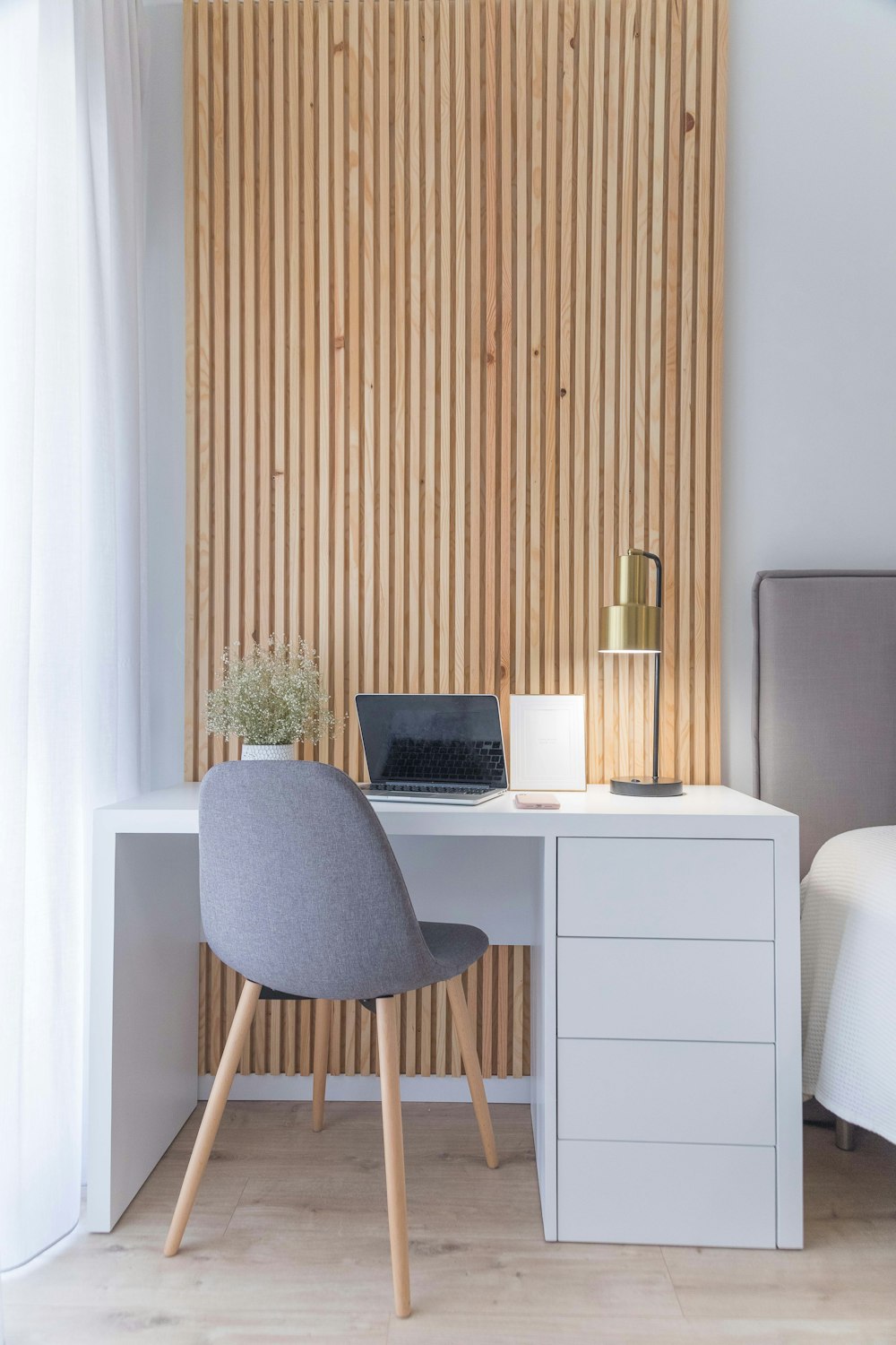 white wooden desk with gray chair